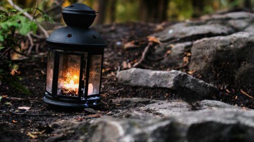 Lantern with a lit candle inside it that I came across in the forest while hiking